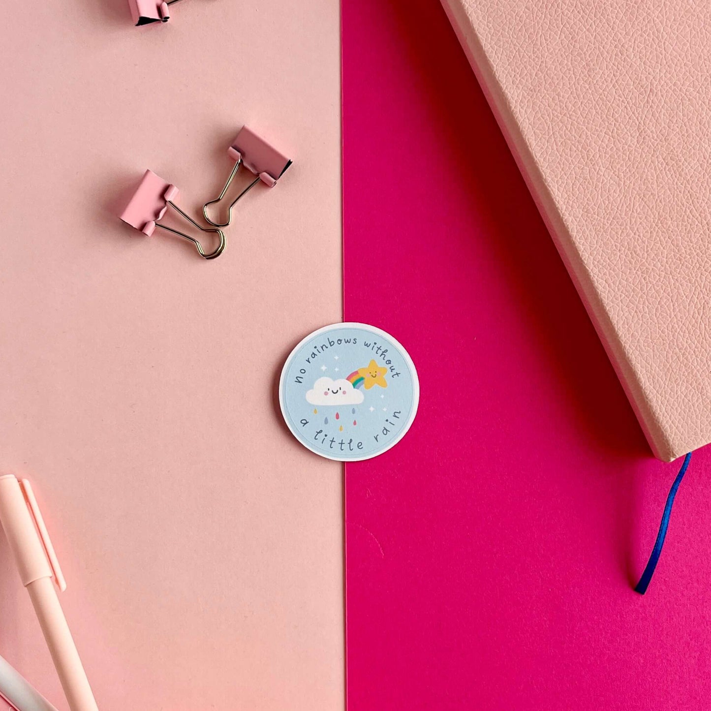 vinyl sticker with kawaii rainbow and star, text reads: no rainbows without a little rain