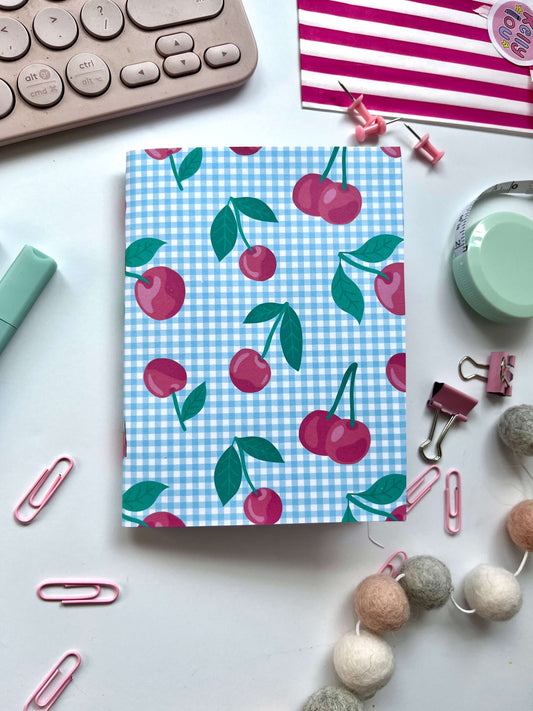 Handmade A5 Notebook with cherry pattern on a desk with office supplies
